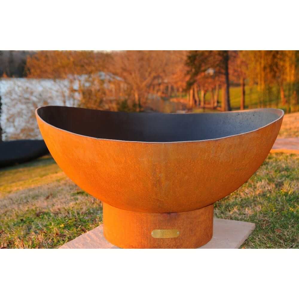Fire Pit Art Scallop 36-Inch Handcrafted Carbon Steel Gas Fire Pit - next to some trees