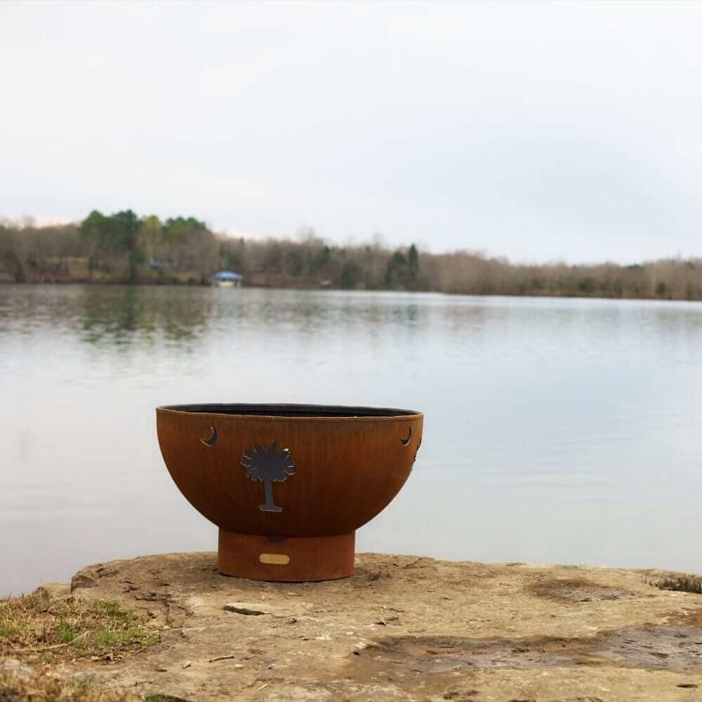 Fire Pit Art Tropical Moon 36-Inch Handcrafted Carbon Steel Gas Fire Pit - next to a lake