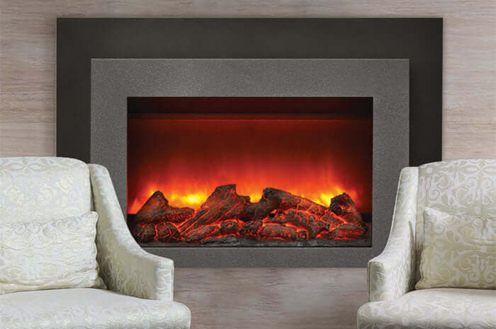 Sierra Flame 30-inch Electric Fireplace Insert - A cozy fireplace with two inviting chairs positioned in front.