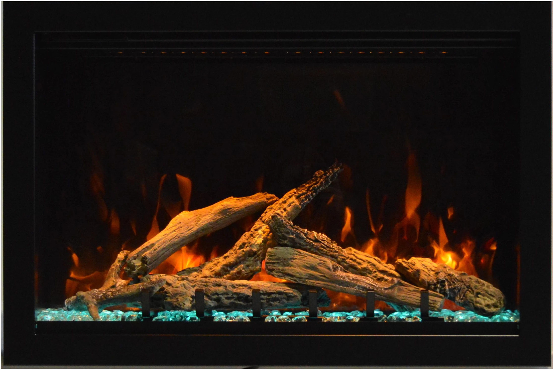 Amantii TRD Lumina Electric Fireplace - Electric fireplace with glowing logs and flames against a dark background