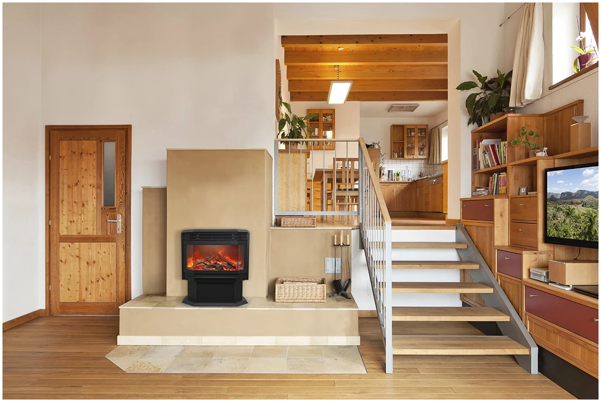 Amantii FS-26-922-LUMINA Freestanding Electric Fireplace - Modern living room with a fireplace, staircase, and kitchen in the background.