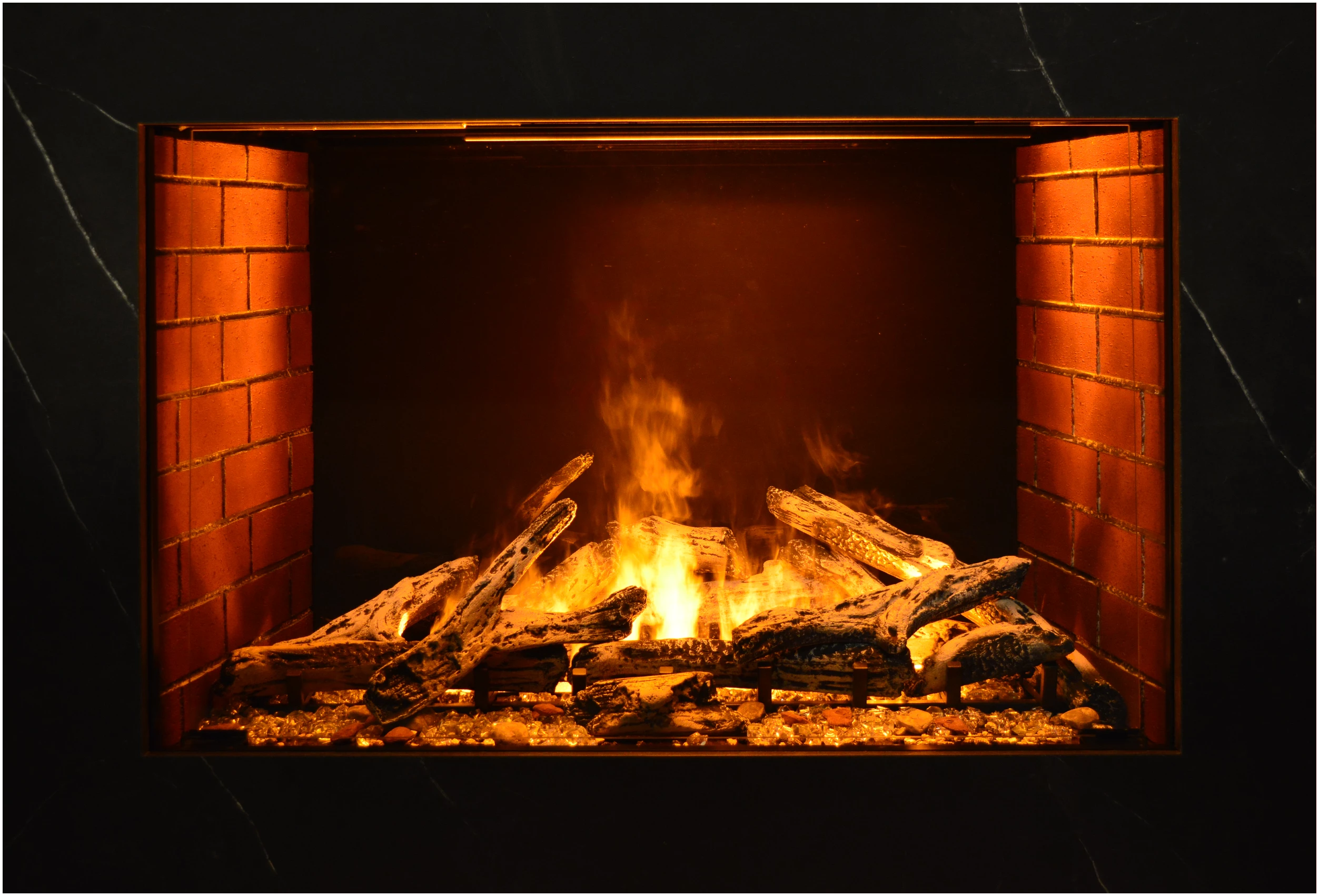 Amantii TRD Signature Series TRD-38-SIG - Fireplace with burning logs and flames inside a brick fireplace.