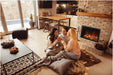Amantii TRD-30-BESPOKE Electric Fireplace - Three women sitting on a rug in front of a fireplace in a cozy living room.