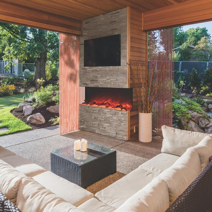 Amantii TRU-VIEW 60-Inch Indoor /Outdoor 3-Sided Smart Electric Fireplace (60-TRU-VIEW-XL) - An inviting outdoor living area featuring a cozy fireplace surrounded by comfortable couches.