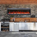 Amantii Symmetry Bespoke Electric Fireplace - An inviting outdoor kitchen showcasing a rustic fireplace and a modern grill
