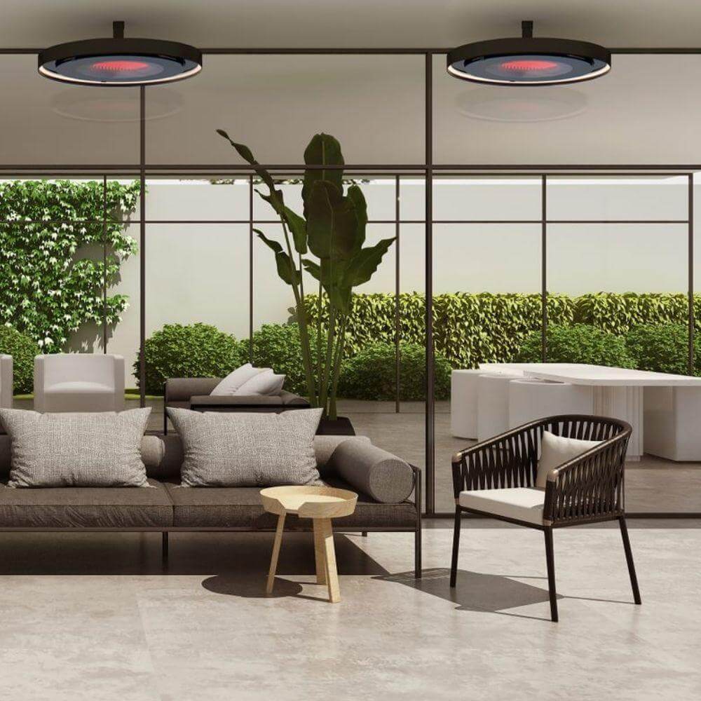 Stylish Bromic Eclipse Smart-Heat ceiling-mounted electric heater in modern indoor setting with comfortable seating.
