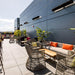 Modern outdoor terrace with Bromic Platinum heaters, stylish seating, and vibrant plants for a cozy atmosphere.