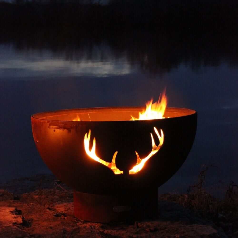 Fire Pit Art Antlers 36-Inch Handcrafted Carbon Steel Gas Fire Pit - next to body of water