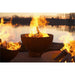 Fire Pit Art Crater 36-Inch Handcrafted Carbon Steel Fire Pit (CTR) - Three fire pits with flames burning near a body of water.