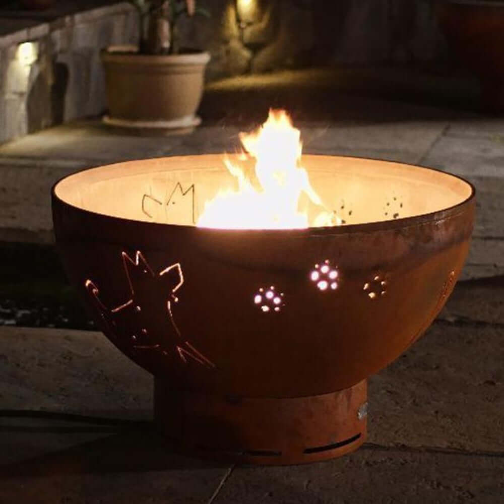 Fire Pit Art Funky Dog 36-Inch Handcrafted Carbon Steel Gas Fire Pit - Fire pit with paw prints on a stone patio