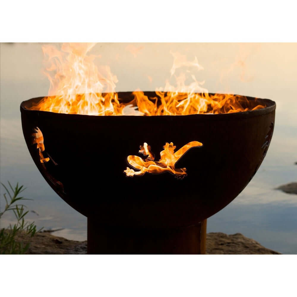 Fire Pit Art Kokopelli 36-Inch Handcrafted Carbon Steel Fire Pit (KO) - Fire pit with flames burning against a natural background