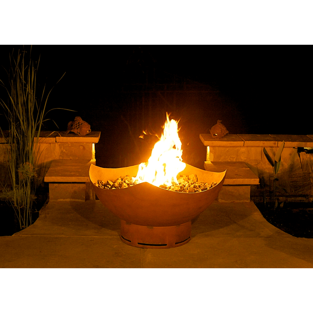 Fire Pit Art Manta Ray 36-Inch Handcrafted Carbon Steel Gas Fire Pit - Fire pit with flames glowing in an outdoor setting at night.