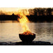 Fire Pit Art Nepal 41-Inch Handcrafted Carbon Steel Fire Pit (NP) - Fire pit on a lake with flames reaching high above the water at sunset.