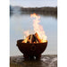 Fire Pit Art Nepal 41-Inch Handcrafted Carbon Steel Fire Pit (NP) - Fire pit with flames burning on a rock by a body of water
