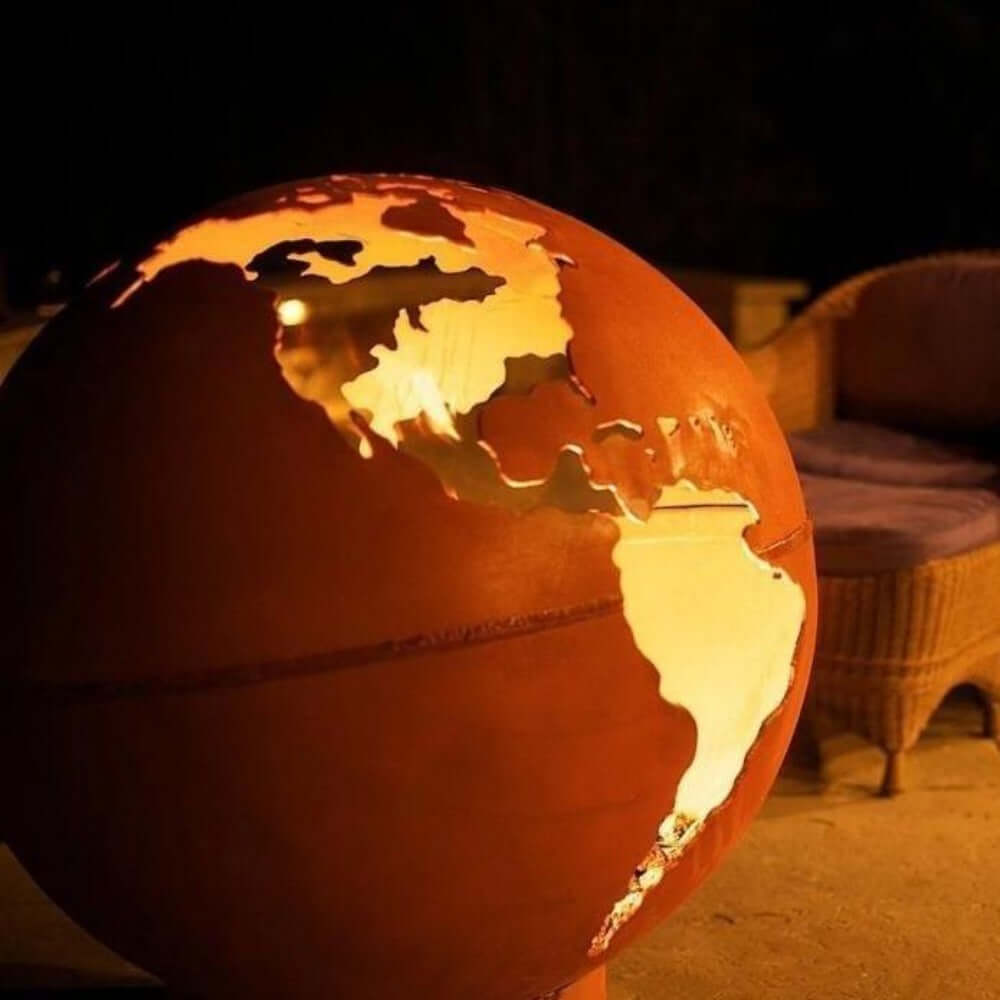 Fire Pit Art Third Rock 36-Inch Carbon Steel Gas Fire Globe - Glowing world map globe in a dimly lit room