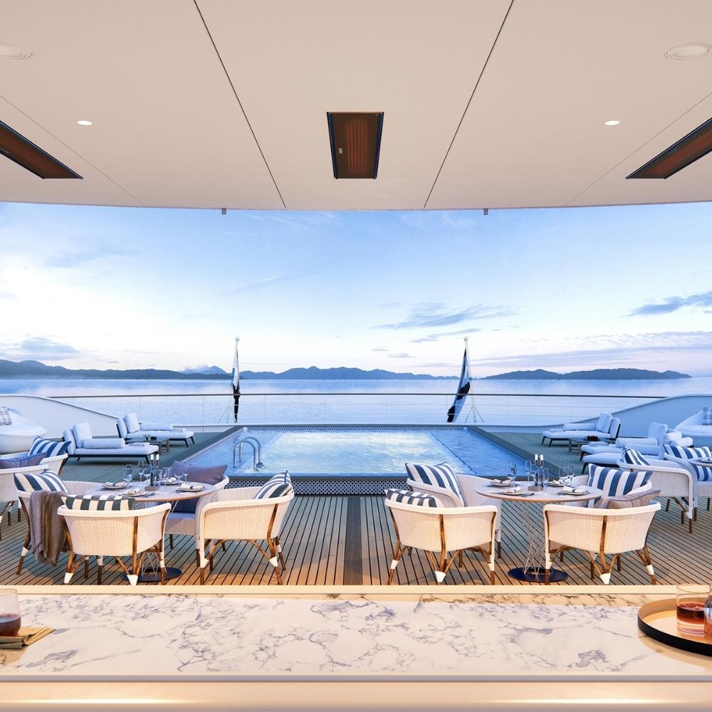 Stylish outdoor seating area with a view of a pool and ocean, featuring elegant furniture and serene atmosphere.