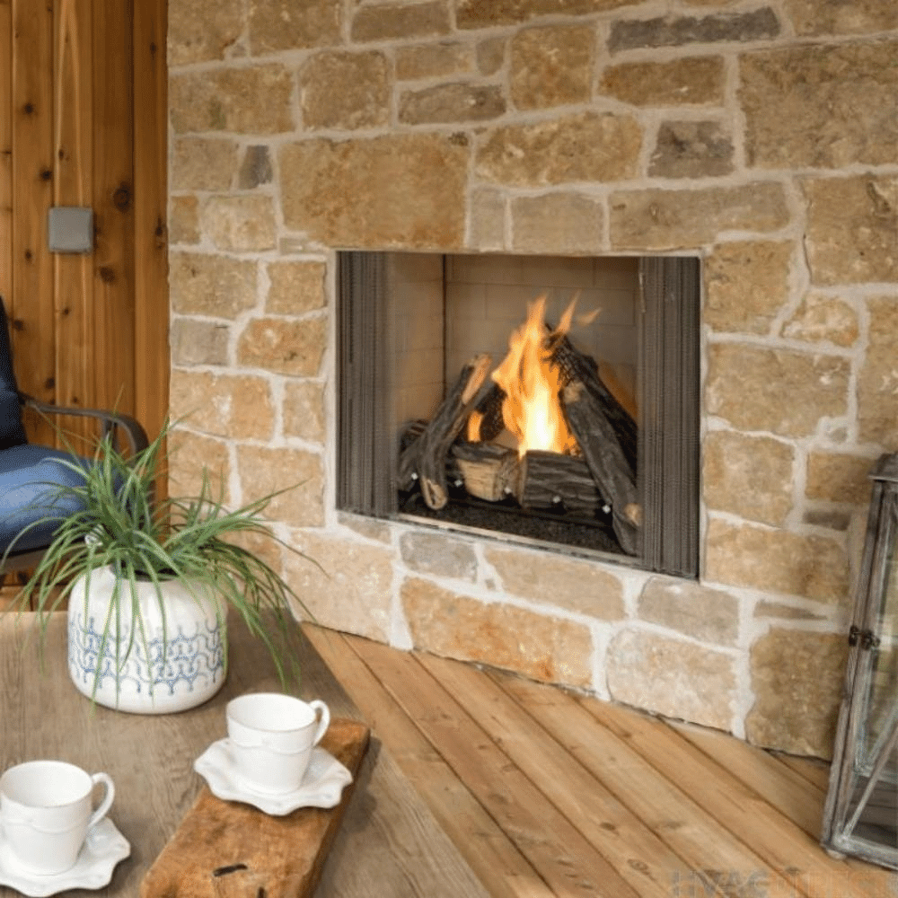 Majestic courtyard vent-free outdoor natural gas fireplace surrounded by stone, showcasing a cozy flame and stylish decor.
