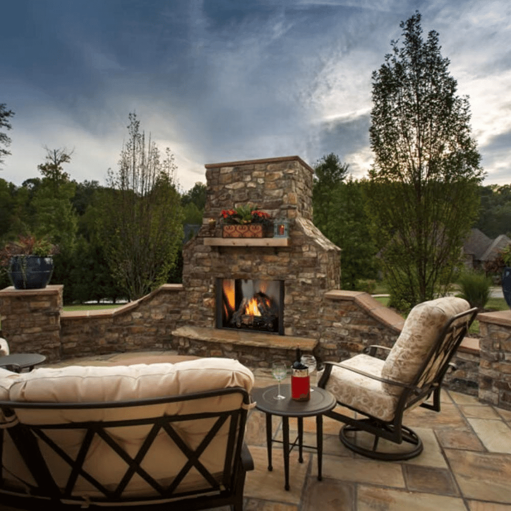 Majestic outdoor natural gas fireplace in a picturesque courtyard setting with cozy seating.