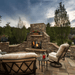 Majestic outdoor natural gas fireplace in a picturesque courtyard setting with cozy seating.
