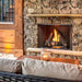 Cozy vent-free outdoor gas fireplace with natural stone surround and glowing flames.