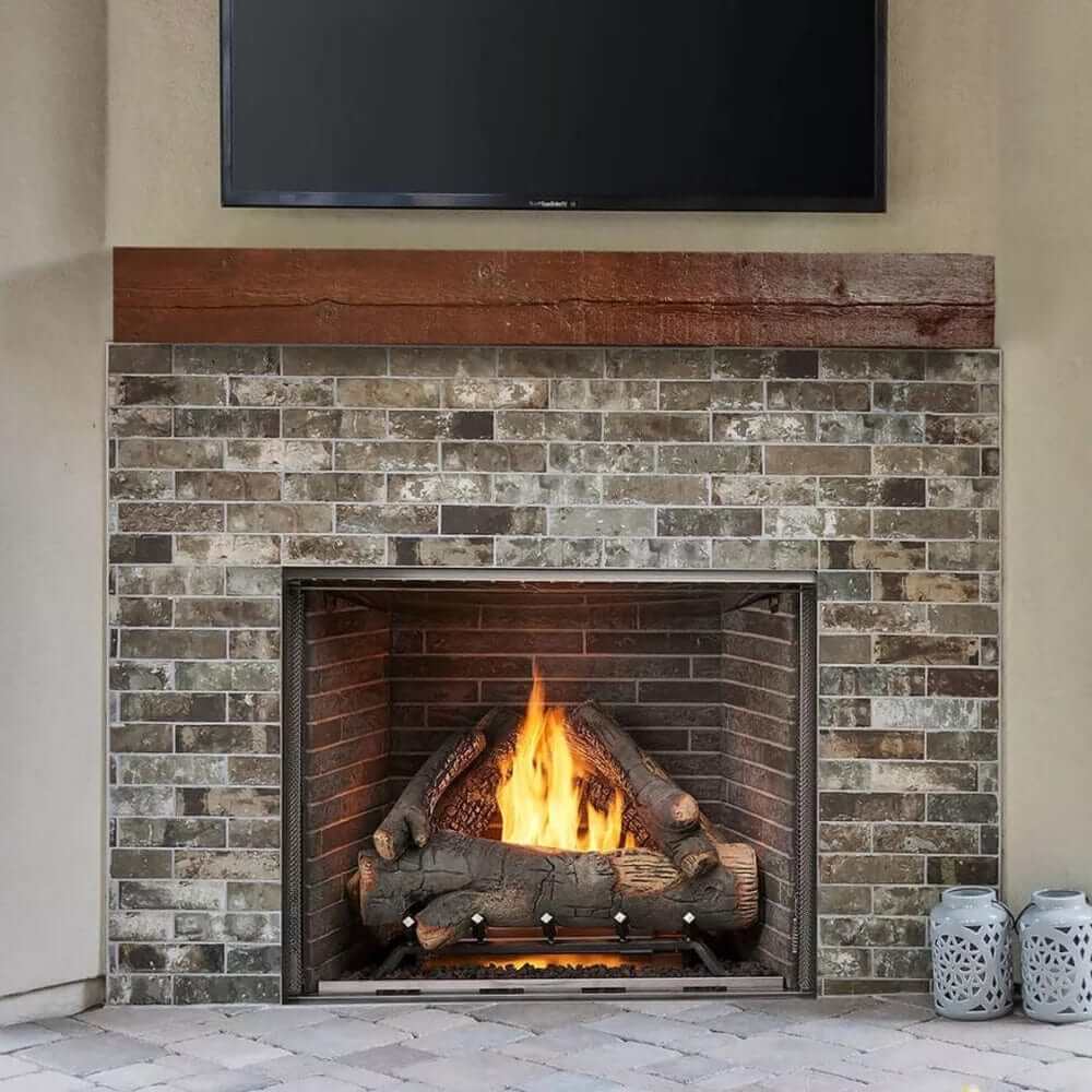 Vent-free outdoor natural gas fireplace with realistic flames in a masonry-style setting.
