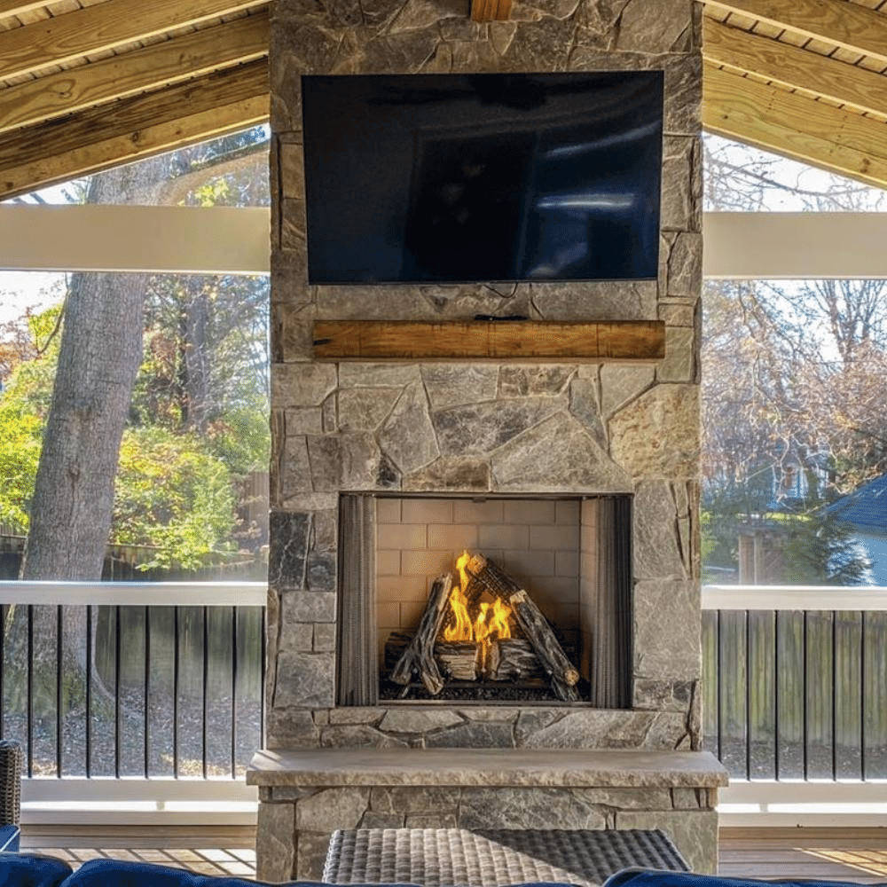 Majestic Courtyard vent-free outdoor fireplace with realistic flames and stone surround under a wooden roof.