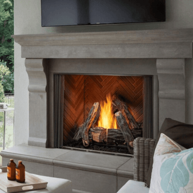 Vent-free outdoor natural gas fireplace with realistic logs and flames in a stylish gray stone mantel.