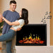 Modern Flames Orion Multi Built-In/Wall Mounted Smart Virtual Electric Fireplace - Couple dancing in front of a modern electric fireplace with decorative music notes on the wall.