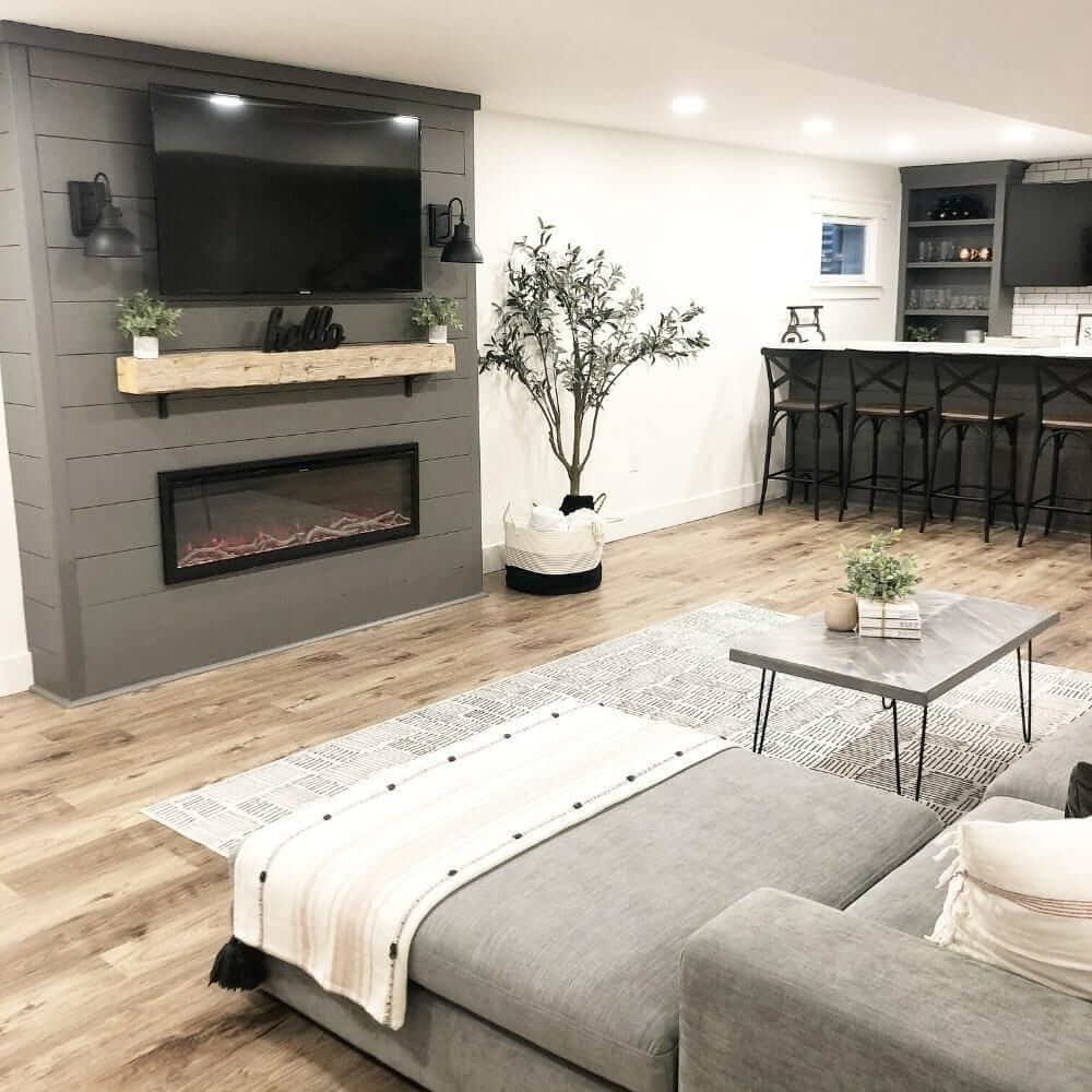 Spectrum Slimline Built-in/Wall Mounted Electric Fireplace - Cozy modern living room with a gray sectional, wall-mounted TV, electric fireplace, and a stylish bar area. Elegant decor accents.