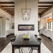 Modern dining area featuring Napoleon CLEARion Elite see-through electric fireplace between two rooms.