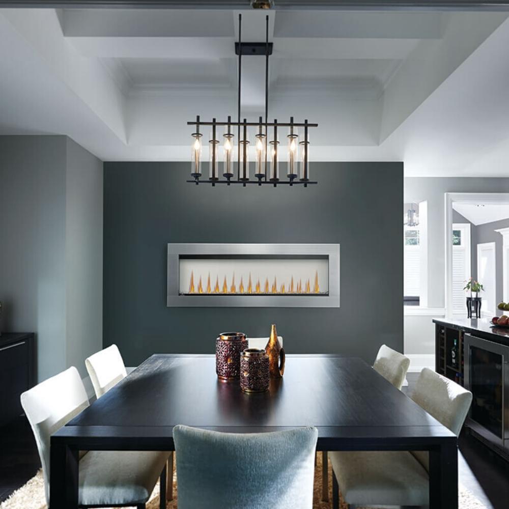 Modern dining room featuring a sleek table, stylish chairs, and a two-sided electric fireplace.