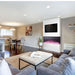 Modern living room featuring a 3-sided built-in electric fireplace with multicolored flames and stylish furniture.