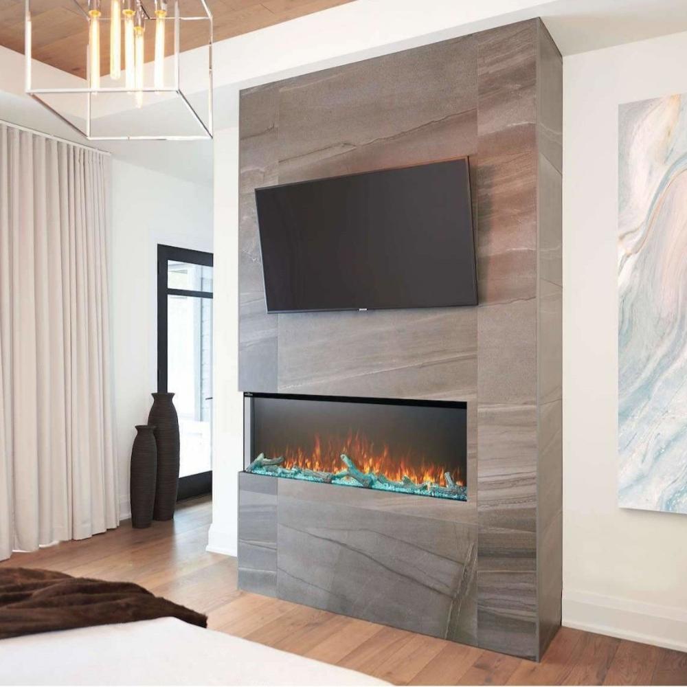 Modern living room featuring a Napoleon Trivista 3-sided electric fireplace with multicolored flames and TV above.