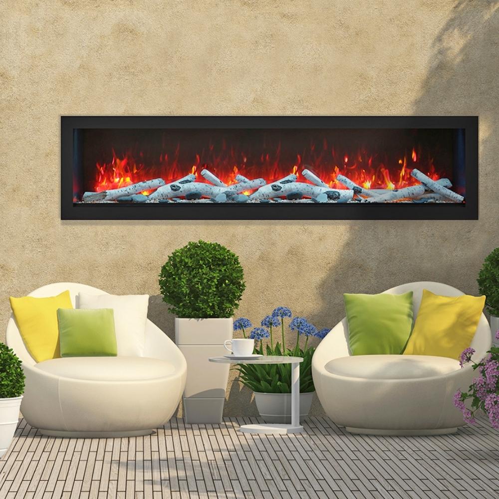 Remii DEEP Full Flame Indoor/Outdoor Frameless Built-in Electric Fireplace - A cozy outdoor fireplace surrounded by two white chairs and a small table