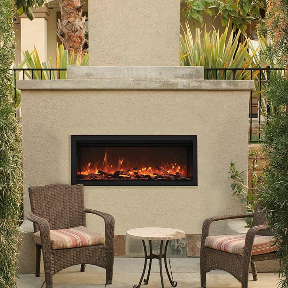 Remii Extra Tall Indoor/Outdoor Frameless Built-in Electric Fireplace - A charming patio scene with a glowing fireplace and two chairs