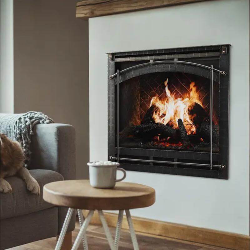 SimpliFire Inception Built-In Electric Fireplace - A dog comfortably seated on a couch beside a warm, glowing fireplace.