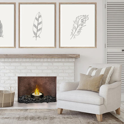 The Bio Flame 13-Inch Grate Kit Round Ethanol Fireplace Insert - Three elegant framed prints of colorful feathers displayed on a pristine white wall