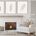 The Bio Flame 13-Inch Grate Kit Round Ethanol Fireplace Insert - Three elegant framed prints of colorful feathers displayed on a pristine white wall