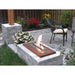 The Bio Flame 24-Inch Indoor/Outdoor Ethanol Fireplace Burner - A colorful backyard with an abundance of flowers and a stone fireplace