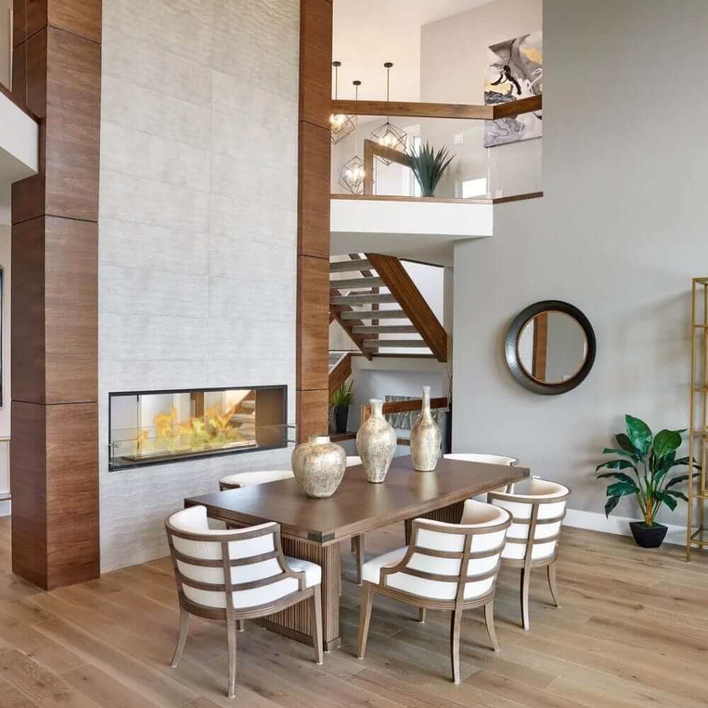 The Bio Flame 72-Inch Firebox DS - Built-in See-Through Ethanol Fireplace - A sleek dining room featuring a cozy fireplace and elegant wood floors