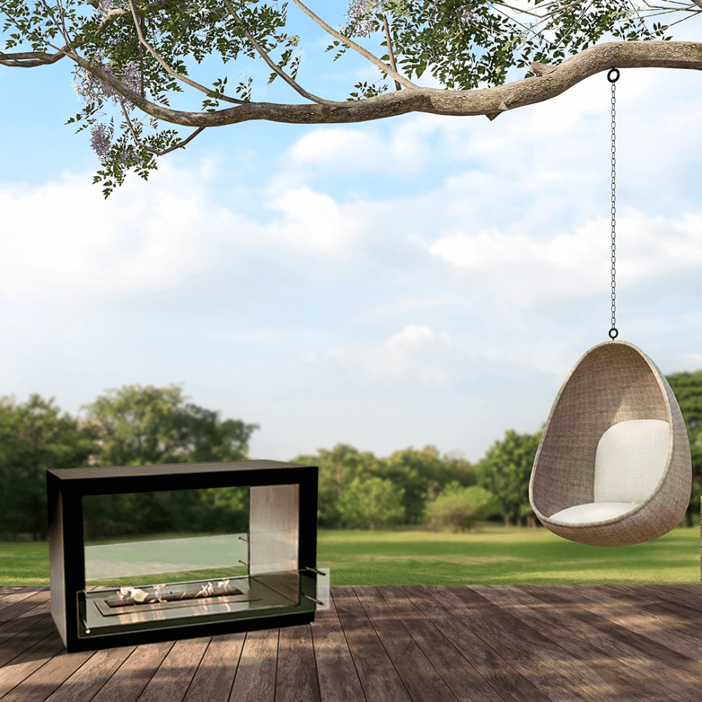 The Bio Flame Sek XL 53-Inch Free Standing See-Through Ethanol Fireplace - A serene yard featuring a swing gently swaying from a sturdy tree and a fireplace