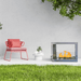 The Bio Flame Sek XL 53-Inch Free Standing See-Through Ethanol Fireplace - A modern outdoor fireplace radiating warmth, paired with a vibrant pink chair