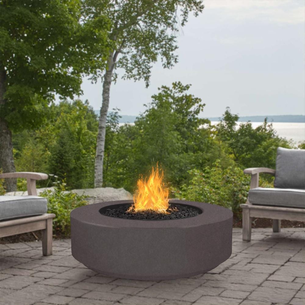 Outdoor Plus Florence 42-Inch GFRC Gas Fire Pit - Match Lit (OPT-FL42) - grey next to some lounge chair and trees