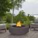 Outdoor Plus Florence 42-Inch GFRC Gas Fire Pit - Match Lit (OPT-FL42) - grey next to some lounge chair and trees