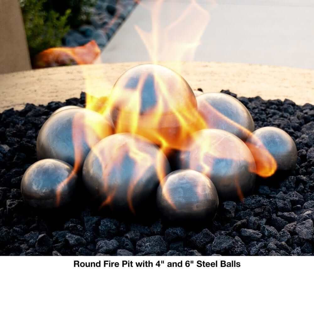 Outdoor Plus Olympian 60" 4-Way Copper Gas Fire and Water Bowl - Match Lit (OPT-OLS60S) - Round fire pit with 4" and 6" steel balls on a bed of black stones.