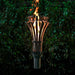Outdoor Plus 14-Inch Gothic Stainless Steel Gas Torch - next to a greenery