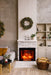 Classic Edition Electric Fireplace by Fire & Ice - Cozy living room with a fireplace, wreath, and decorative items.