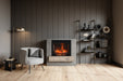 Classic Edition Electric Fireplace by Fire & Ice - Modern living room with a fireplace, armchair, and bookshelf.