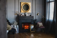 Classic Edition Electric Fireplace by Fire & Ice - Cozy living room with a fireplace, decorative mirror, and soft lighting.