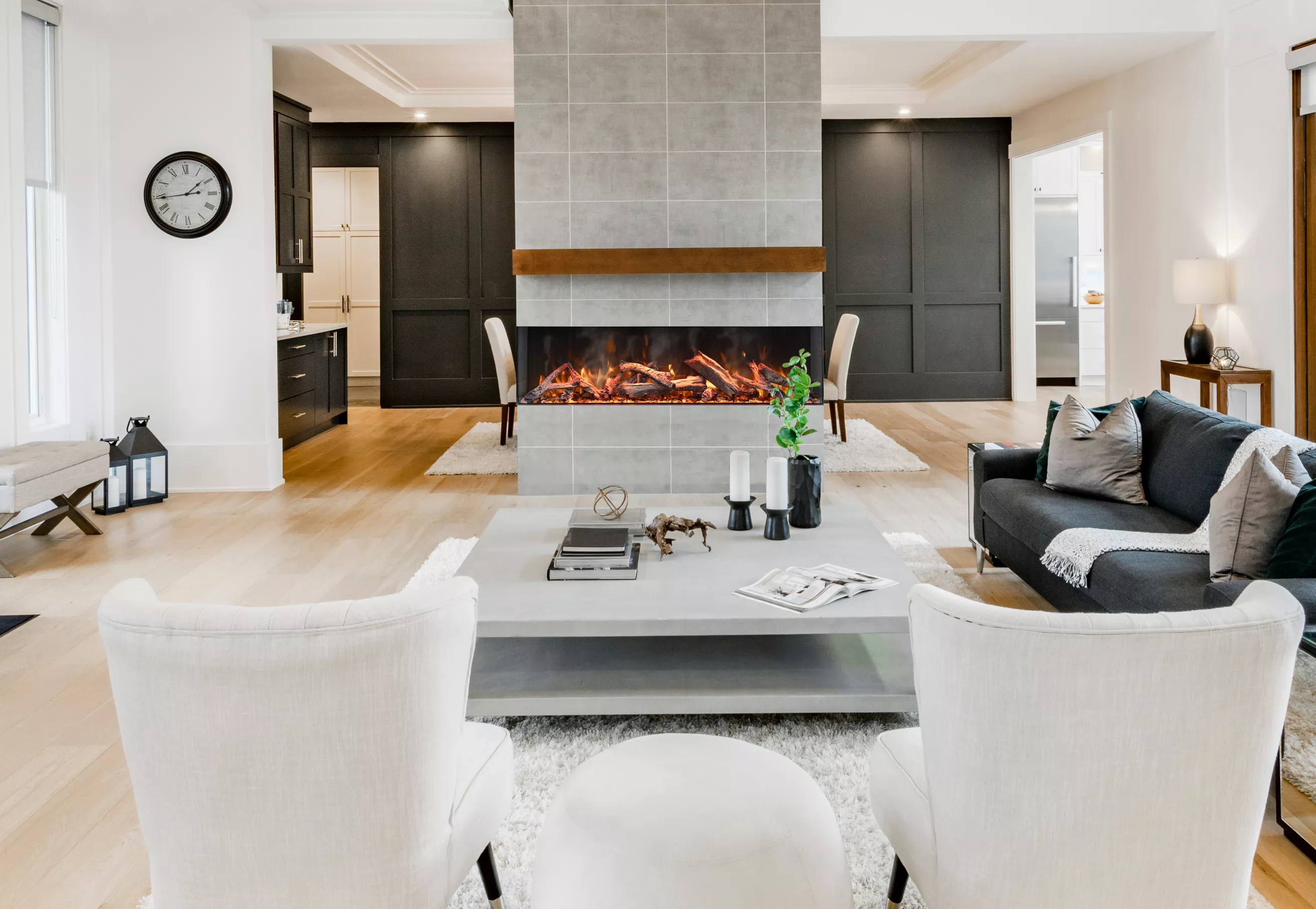 Amantii TRU-VIEW SIGNATURE Electric Fireplace - Modern living room with a fireplace, white chairs, and a coffee table.